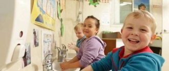 Children wash their hands and laugh