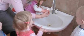Children with a teacher teach a doll to wash and wash hands
