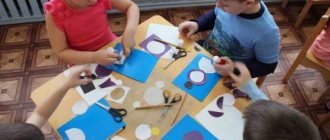 Children make appliqués from colored paper